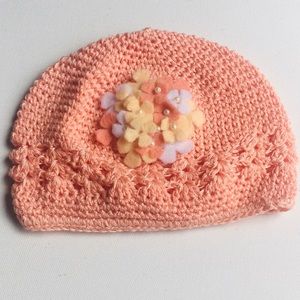 Pink knit hat for baby girl with floral piece